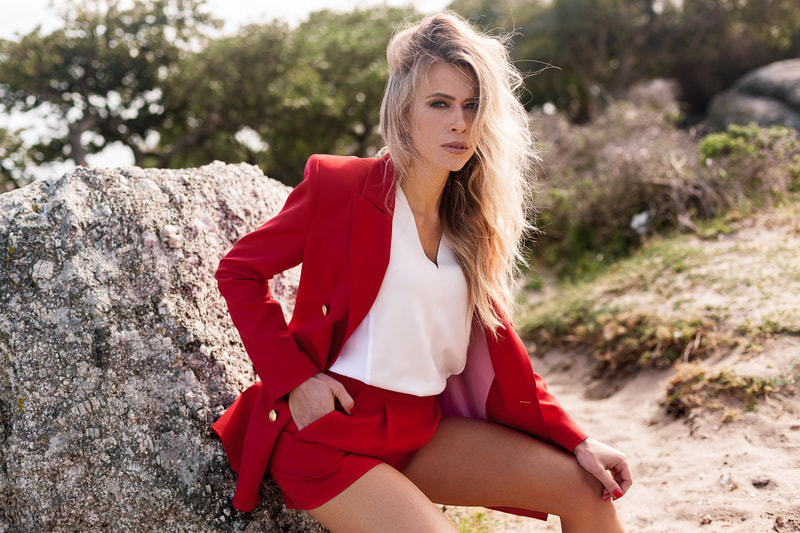 woman modelling red suit during golden hour on the beach